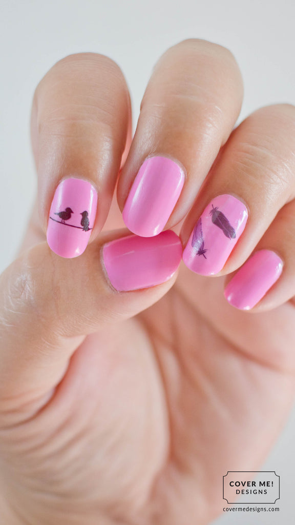 Pink nail art with black birds and feathers