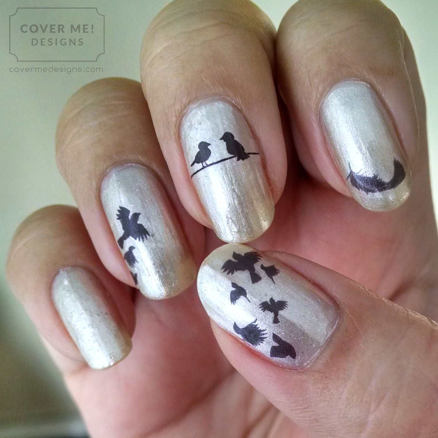 metallic silver nails with black bird nail art decals