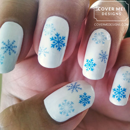 Blue snowflakes on white nail polish nail art design